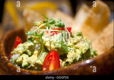 fresh avocado and shrimps salad with nachos on side Stock Photo