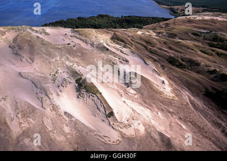 Aerial view of a strip of moving dunes on the Lagoon side between Juodkrante and Pervalkaon the Curonian Spit a 98 km long, thin, curved sand-dune spit that separates the Curonian Lagoon from the Baltic Sea coast in Lithuania Stock Photo