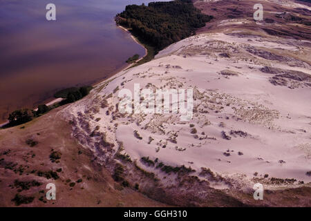 Aerial view of a strip of moving dunes on the Lagoon side between Juodkrante and Pervalkaon the Curonian Spit a 98 km long, thin, curved sand-dune spit that separates the Curonian Lagoon from the Baltic Sea coast in Lithuania Stock Photo