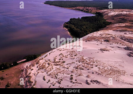 Aerial view of a strip of moving dunes on the Lagoon side between Juodkrante and Pervalkaon the Curonian Spit a 98 km long, thin, curved sand-dune spit that separates the Curonian Lagoon from the Baltic Sea coast in Lithuania Stock Photo