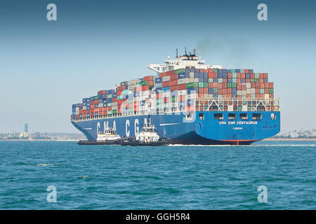 The Giant CMA CGM Centaurus, New Panamax Container Ship Is Manoeuvred Into The Long Beach Container Terminal, California, USA. Stock Photo