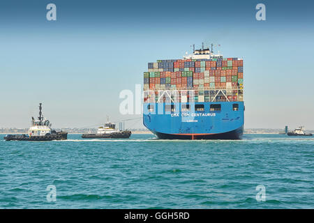 The Giant CMA CGM Centaurus New Panamax Container Ship Is Manoeuvred Into The Long Beach Container Terminal, California, USA. Stock Photo