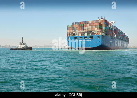 The Giant CMA CGM Centaurus New Panamax Container Ship Is Manoeuvred Into The Long Beach Container Terminal, California, USA. Stock Photo