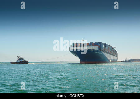 The Giant CMA CGM Centaurus New Panamax Container Ship Is Manoeuvred Into The Long Beach Container Terminal, California, USA. Stock Photo