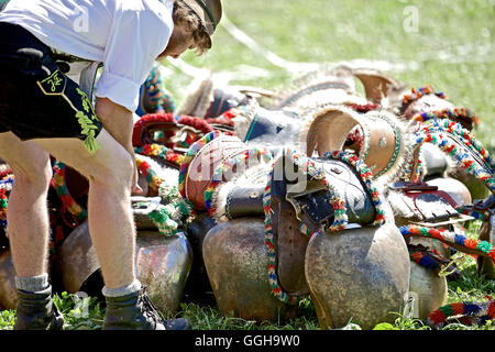 Man wearing traditional clothes near several cow bells, Viehscheid, Allgau, Bavaria, Germany Stock Photo