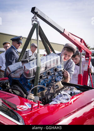 Mechanics changing the engine of a Ford Mustang, Goodwood Revival 2014, Racing Sport, Classic Car, Goodwood, Chichester, Sussex, Stock Photo