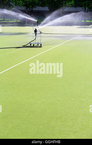 Watering artificial turf on the football stadium Stock Photo