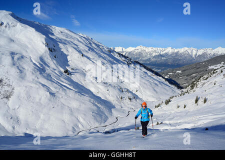 Female back-country skier ascending to Kleiner Gilfert, Karwendel in background, Kleiner Gilfert, Tux Alps, Tyrol, Austria Stock Photo
