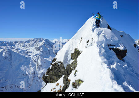 Female back-country skier ascending to Aeusseres Hocheck, Pflersch valley, Stubai Alps, South Tyrol, Italy Stock Photo