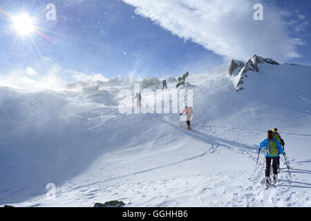 Back-country skiers ascending through snowstorm to Regenfeldjoch, Langer Grund, Kitzbuehel Alps, Tyrol, Austria Stock Photo