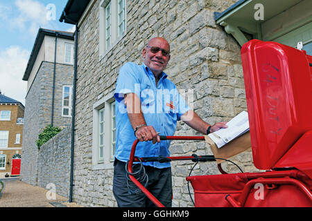 Postman in Poundbury, Dorchester, Dorset, England, Great Britain Stock Photo