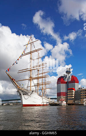 Skyscraper Lilla Bommen and a historic tall ship in the port of Gothenburg, Sweden Stock Photo
