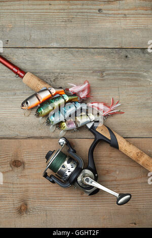https://l450v.alamy.com/450v/gght2f/lot-of-colorful-lures-with-the-fishing-rod-on-the-wooden-pier-gght2f.jpg