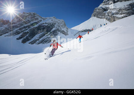 Skiers downhill skiing from mount Zugspitze, Upper Bavaria, Germany Stock Photo