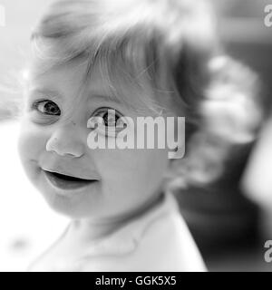 Smiling baby girl with big eyes (black and white photo using Lensbaby technique), Borden, Western Australia, Australia Stock Photo
