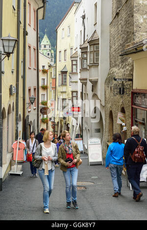 Persons walking along alley Langer Graben in old town, Hall, Tyrol, Austria Stock Photo