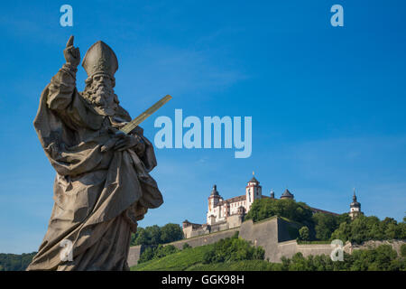 Statue on Alte Mainbruecke bridge across the Main river with Marienberg fortress on the hillside, Wuerzburg, Franconia, Bavaria, Stock Photo