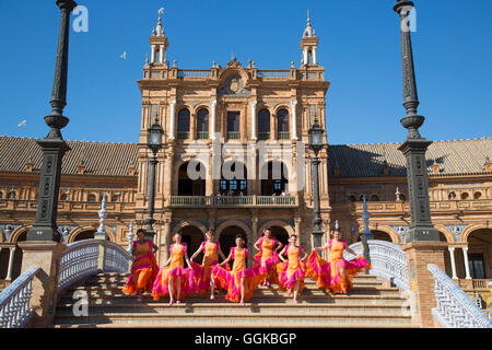 Members of Flamenco Fuego dance group running down the steps at Plaza de Espana, Seville, Andalusia, Spain