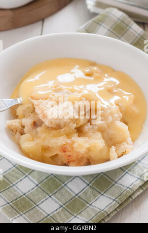 Home made apple crumble or apple cobbler with vanilla custard Stock Photo