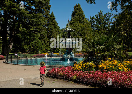 Young boy near The Peacock Fountain in Christchurch Botanic Gardens, Christchurch, Canterbury, South Island, New Zealand Stock Photo