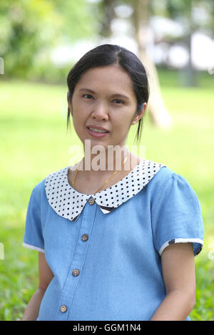 Asian pregnant woman is leisure in the public park and is made brilliant mind because it makes baby good healthy. Stock Photo