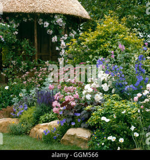 Summer House - with lush Summer planting - (Please Credit: Photos Hort/Daily Mirror at Hampton Ct - Show 1996)   SUH06 Stock Photo