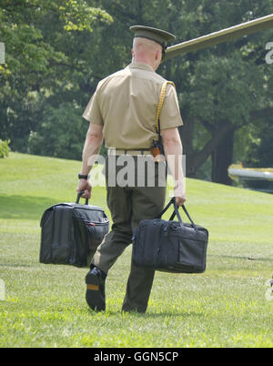 Washington, District of Columbia, USA. 6th Aug, 2016. A United States Marine carries the bags containing the nuclear codes as US President Barack Obama and members of the first family departs the White House in Washington, DC on Saturday, August 6, 2016 to travel to Martha's Vineyard, Massachusetts for their annual two week vacation. Credit: Ron Sachs/Pool via CNP Credit:  Ron Sachs/CNP/ZUMA Wire/Alamy Live News Stock Photo