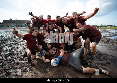 Woellnau, Germany. 06th Aug, 2016. The team Rote Ruebe Roitzsch poses at the German Championship in Mud Soccer in Woellnau, Germany, 06 August 2016. The winners of the playful championship qualify for the World Championship in Finland. Photo: ALEXANDER PRAUTZSCH/dpa/Alamy Live News Stock Photo