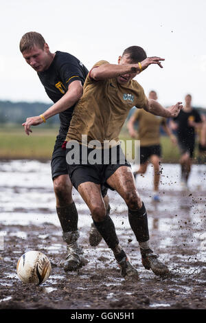 Woellnau, Germany. 06th Aug, 2016. Players with the Schenkenberger Schlammpen and the 'Rotte' compete in the finale at the German Championship in Mud Soccer in Woellnau, Germany, 06 August 2016. The winners of the playful championship qualify for the World Championship in Finland. Photo: ALEXANDER PRAUTZSCH/dpa/Alamy Live News Stock Photo