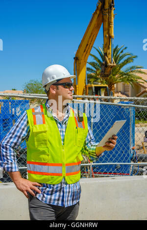 Caucasian construction worker holding digital tablet Stock Photo