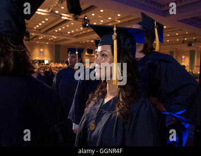 Student waits to receive diploma at commencement ceremony for Western Governors University, a fully accredited online university Stock Photo