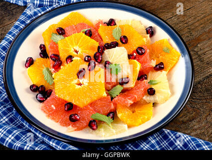 Fresh Citrus Salad with pomegranate seeds and mint. Healthy diet eating Stock Photo