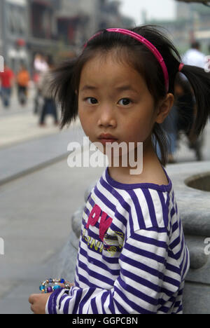 A young girl on Qianmen Street, one of Beijing’s best-preserved areas of historical sites. Beijing – China Stock Photo