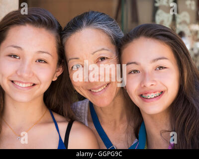 Close up of smiling Asian mother and daughters Stock Photo