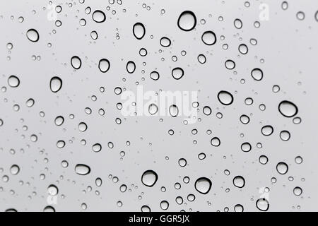 Drop of water for the background on glass car window to abstract design and nature backdrop. Stock Photo