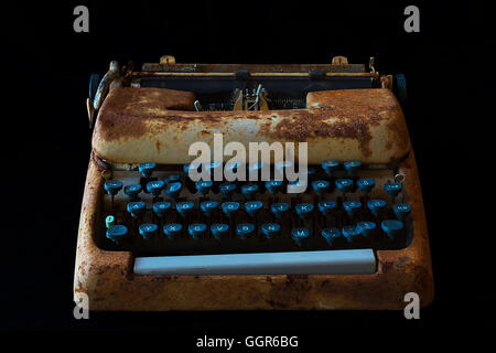 Typewriter, Waiting for Inspiration. Vintage Rusty Typewriter Machine. Typewriter Isolated on Black Background. Stock Photo