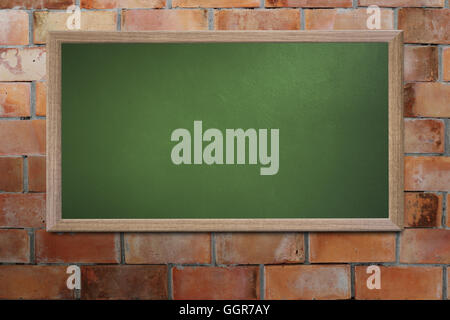 Blank old school blackboard on a grunge wall and can input text or data to wooden frame for concept of education. Stock Photo