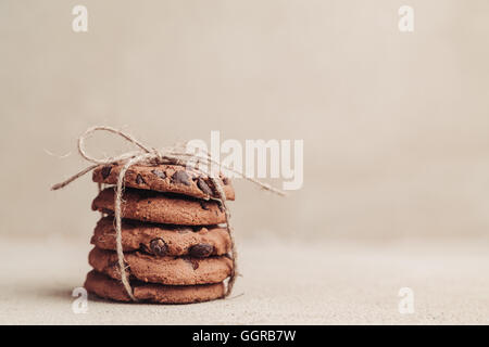 Stacked chocolate chip cookies on grey table Stock Photo