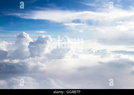 towering cloud formations viewed from an airplane window at a high elevation Stock Photo