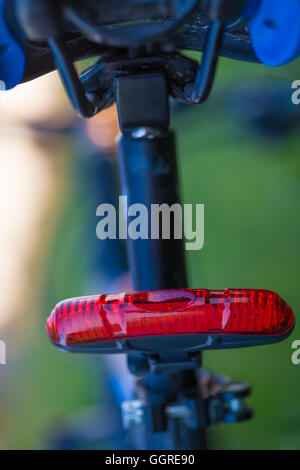 Rear red bicycle lamp installed at the seatpost Stock Photo