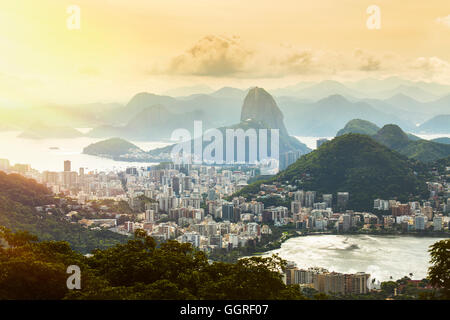 Rio de Janeiro at sunset with the Lagoa (de Rodrigo de Freitas) right of frame, Copacabana and Ipanema neighbourhoods, and the Sugar Loaf mountain Stock Photo