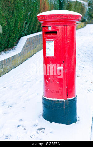 An English post box in a snowy winter Stock Photo
