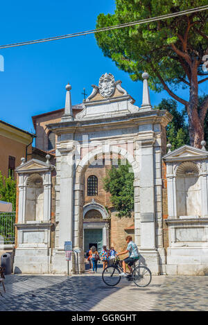 Cyclist crossing the principal entry of the Basilica of San Vitale in Ravenna, Emilia-Romagna. Italy. Stock Photo