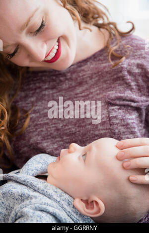 Caucasian woman holding baby son in lap Stock Photo