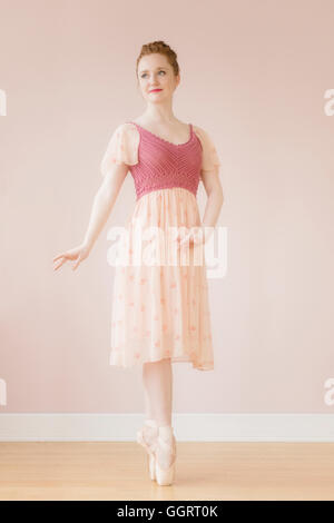 Caucasian ballerina standing en pointe Stock Photo