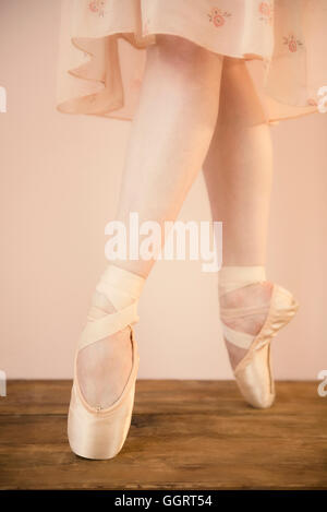 Caucasian ballet dancer standing en pointe Stock Photo