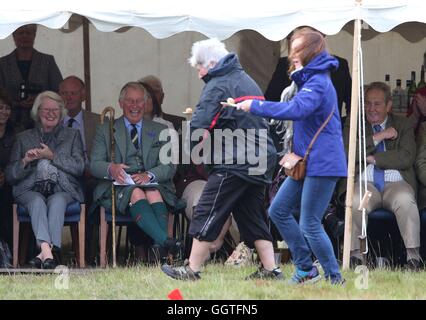 The Prince of Wales, also known as the Duke of Rothesay, watches an egg and spoon race as he attends the Mey Highland games which were held in a nearby field to John O' Groats, Scotland, due to a waterlogged field in Mey. Stock Photo