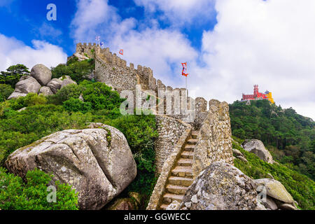 Sintra, Portugal at Castle of the Moors wall with Pena National Palace in the distance. Stock Photo