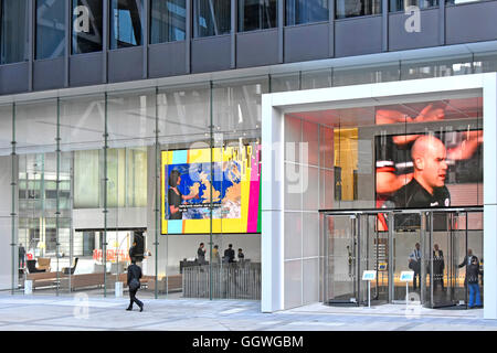 Giant sized flat television screen screens in reception foyer of Aviva Insurance headquarters building in St Helen's Tower City of London England UK Stock Photo