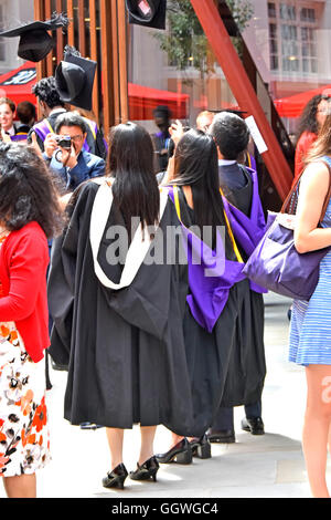 London School of Economics & Political Science students on graduation day mortar boards being thrown in air at LSE university in Holborn England UK Stock Photo